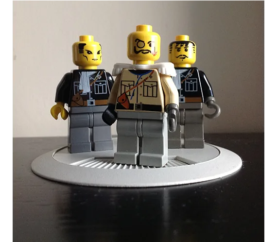 LEGO minifigure villains posed on a display stand