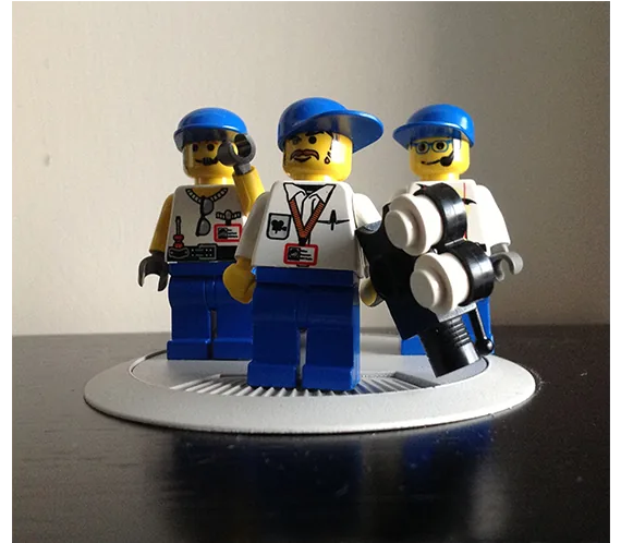 LEGO minifigure camera crew in blue caps on a display stand